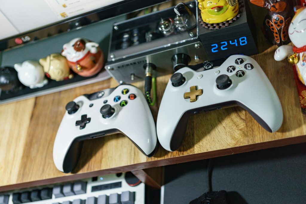 pexels-photo-245252-245252 Top view of a gaming setup with controllers and decorative figures on a wooden table.